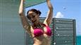 Elli AvrRam shows off her riding skills in the Maldives sporting a bikini with a vibrant colored shrug!