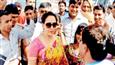 Hema Malini colour co-ordinates her umbrella with her sari