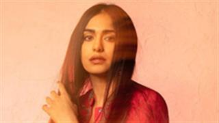 Adah Sharma paints the town red in a tassel bodysuit and jacket accoutre!