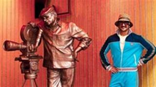 Ranveer Singh looks handsome and sporty in his cool, modernistic avatar as he poses with the statue!