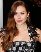 Elizabeth Olsen poses as she arrives for the British Academy of Film and Arts (BAFTA) awards ceremony at the Royal Opera House in London