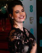 Actress Lily James poses as she arrives for the British Academy of Film and Arts (BAFTA) awards ceremony at the Royal Opera House in London