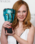 Juno Temple celebrates after winning the Award for Rising Star at the British Academy of Film and Arts (BAFTA) awards ceremony at the Royal Opera House in London