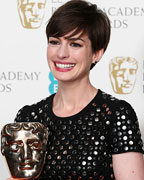 Anne Hathaway celebrates after winning the Best Supporting Actress award for Les Miserables at the British Academy of Film and Arts (BAFTA) awards ceremony at the Royal Opera House in London