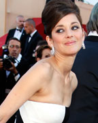 Cast member Marion Cotillard poses on the red carpet as she arrives for the screening of the film 'Blood Ties' during the 66th Cannes Film Festival