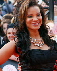 The cast of eTalk, (L-R) Traci Melchor, Danielle McGimsie and Tanya Kim arrive on the red carpet for the MuchMusic Video Awards (MMVAs) in Toronto