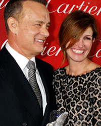 Actor Tom Hanks, star of the films `Captain Phillips` and Saving Mr. Banks` poses backstage with his Chairman`s Award and presenter actress Julia Roberts at the 2014 Palm Springs International Film Festival Awards Gala in Palm Springs, California