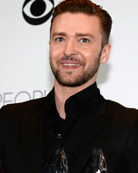 Singer Justin Timberlake holds the awards he won for favorite album, favorite male artist and favorite R