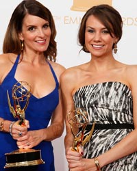 Writers Tina Fey (L) and Tracey Wigfield from NBC's series '30 Rock' pose backstage with their award for Outstanding Writing for a Comedy Series at the 65th Primetime Emmy Awards in Los Angeles