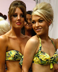 Models wearing swimwear by Anna Lous wait backstage before the presentation of her collection during Liverpool Fashion Week in northern England