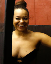 Nouvatan founder Dawn Plummer administers a spray tan to Yasmin Myers during a workshop on how to apply fake tan during Liverpool Fashion Week in northern England