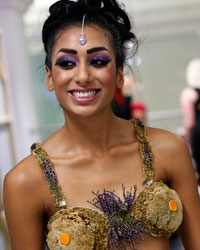 Models, wearing clothing made entirely from plants, wait backstage before the presentation of the Florina collection during Liverpool Fashion Week in northern England