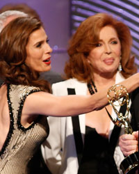 Actress Kristian Alfonso (L) wipes lipstick off the cheek of executive producer Ken Corday as he accepts the outstanding drama series award for 'Days of Our Lives' during the 40th annual Daytime Emmy Awards in Beverly Hills, California