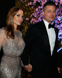 Actors Brad Pitt and Angelina Jolie attend the Governors Ball after the 86th Academy Awards in Hollywood, California March 2, 2014