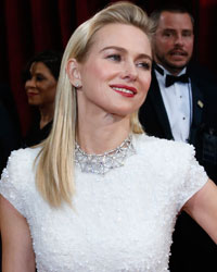 Presenter Naomi Watts, wearing a gown by Calvin Klein, poses as she arrives at the 86th Academy Awards in Hollywood, California March