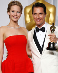 Matthew McConaughey, best actor winner for his role in the film 'Dallas Buyers Club', poses with his Oscar and presenter Jennifer Lawrence at the 86th Academy Awards in Hollywood, California