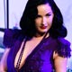 Burlesque artiste Dita von Teese performs a strip-tease as she attends the amfAR`s Cinema Against AIDS 2008 event in Mougins during the 61th Cannes Film Festival