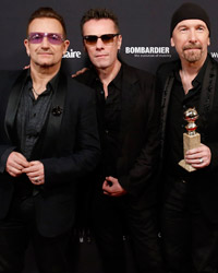 Bono, Adam Clayton, The Edge and Larry Mullen, Jr. from the band U2 pose with their award for Best Original Song for 'Ordinary Love' from the film 'Mandela: Long Walk to Freedom' at The Weinstein Company