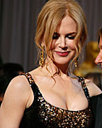 Nicole Kidman, wearing L?Wren Scott dress and Fred Leighton jewels, poses with her husband Keith Urban as they arrive at the 85th Academy Awards