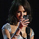 Presenter Jessica Alba takes a photo of the crowd with the camera on her Blackberry cell phone while on stage at the 2010 People`s Choice Awards in Los Angeles