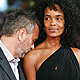 French director Luc Besson kisses his wife Virginie Silla as they pose on the red carpet for the movie 'The Lady', which he directed, at the Rome Film Festival