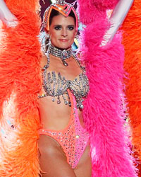 Show host Danica Patrick dressed as a Las Vegas show girl introduces Justin Moore's performance during the 4th annual American Country Awards in Las Vegas, Nevada