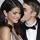 Singer Justin Bieber kisses his girlfriend, singer Selena Gomez, as they arrive at the 2011 American Music Awards