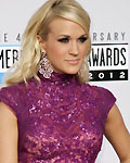 Singer Carrie Underwood poses as she arrives at the 40th American Music Awards in Los Angeles