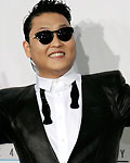 South Korean rapper Psy poses as he arrives at the 40th American Music Awards in Los Angeles