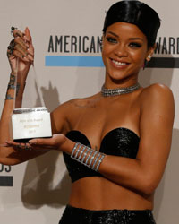 Singer Rihanna poses backstage with her Icon award at the 41st American Music Awards in Los Angeles, California