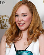 Juno Temple celebrates after winning the Award for Rising Star with presenters Sarah Silverman and John C. Reilly (L) at the British Academy of Film and Arts (BAFTA) awards ceremony at the Royal Opera House in London