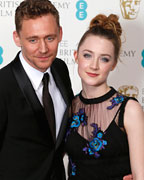 Saoirse Ronan and Tom Hiddleston pose for photographers at the British Academy of Film and Arts (BAFTA) awards ceremony at the Royal Opera House in London