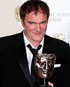 Quentin Tarantino celebrates after winning the Best Original Screenplay award for Django Unchained at the British Academy of Film and Arts (BAFTA) awards ceremony at the Royal Opera House in London