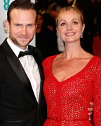 Rafe Spall poses with his wife Elize Du Toit as they arrive for the British Academy of Film and Arts (BAFTA) awards ceremony at the Royal Opera House in London