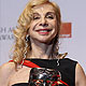 Francesca Lo Schiavo poses after winning the award for production design for 'Hugo' at the BAFTA awards ceremony in London