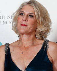 Catherine Martin (R) and Beverley Dunn celebrate winning Film Production Design category for 'The Great Gatsby' while flanked by actress Olga Kurylenko (L) and actor Richard E. Grant at the British Academy of Film and Arts (BAFTA) awards ceremony at the Royal Opera House in London