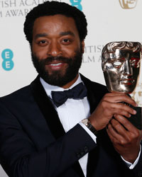 Actor Chiwetel Ejiofor celebrates after winning Best Actor for '12 Years a Slave' at the British Academy of Film and Arts (BAFTA) awards ceremony at the Royal Opera House in London