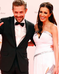 TV presenter Klaas Heufer-Umlauf and his girfriend Doris Golpashin (R) arrive on the red carpet for the Bambi 2013 media awards ceremony in Berlin