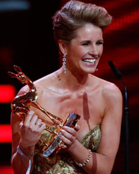 Kamilla Senjo and Mareile Hoeppner (R) address the audience after receiving the Public Bambi during the Bambi 2013 media awards ceremony in Berlin