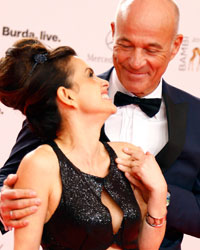 Actor Heiner Lauterbach and his wife Victoria (L) arrive on the red carpet for the Bambi 2013 media awards ceremony in Berlin