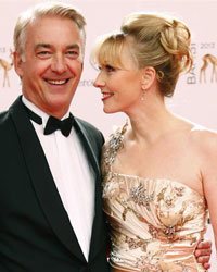 Actor Dominic Raacke and his girfriend Janine Barth (R) arrive on the red carpet for the Bambi 2013 media awards ceremony in Berlin