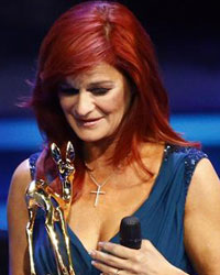 Singer Andrea Berg recives the Special Jury award from TV presenter Kai Pflaume during the Bambi 2013 media awards ceremony in Berlin