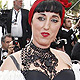 Rossy De Palma (L) arrives with a guest on the red carpet for the screening of the film 'La Piel Que Habito', in competition at the 64th Cannes Film Festival