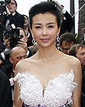 Jackie Chan waves as he arrives on the red carpet with unidentified guests for the screening of the film 'De rouille et d'os', in competition at the 65th Cannes Film Festival