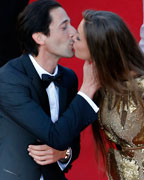 Actor Adrien Brody kisses his partner Lara Lieto on the red carpet as they arrive for the screening of the film 'Behind the Candelabra' in competition during the 66th Cannes Film Festival