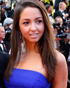 AmfAR Chairman of the Board and designer Kenneth Cole poses with a guest on the red carpet as she arrives for the screening of the film Behind the Candelabra in competition during the 66th Cannes Film Festival