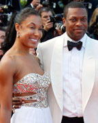 Actor Chris Tucker and a guest pose on the red carpet as they arrive for the screening of the film Behind the Candelabra in competition during the 66th Cannes Film Festival