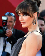 Actress Milla Jovovich poses on the red carpet as she arrives for the screening of the film 'Behind the Candelabra' in competition during the 66th Cannes Film Festival