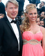 Former Formula One driver Mika Hakkinen poses with his wife Marketa Kromatova on the red carpet as she arrives for the screening of the film Behind the Candelabra in competition during the 66th Cannes Film Festival