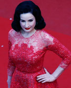 Performer Dita Von Teese poses on the red carpet as she arrives for the screening of the film 'Behind the Candelabra' in competition during the 66th Cannes Film Festival